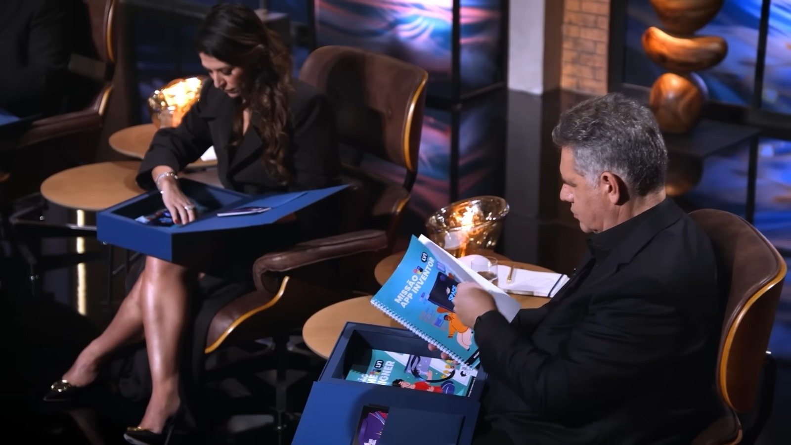 Tubarões do Shark Tank Brasil analisando o kit e a apostila da The Future School 4.0